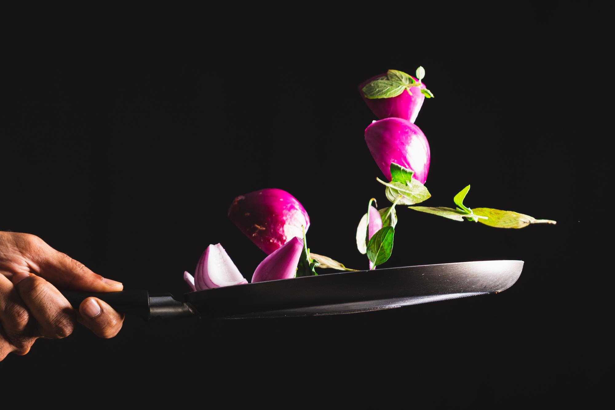 Instructor plating a modern dish with neon kitchen tools